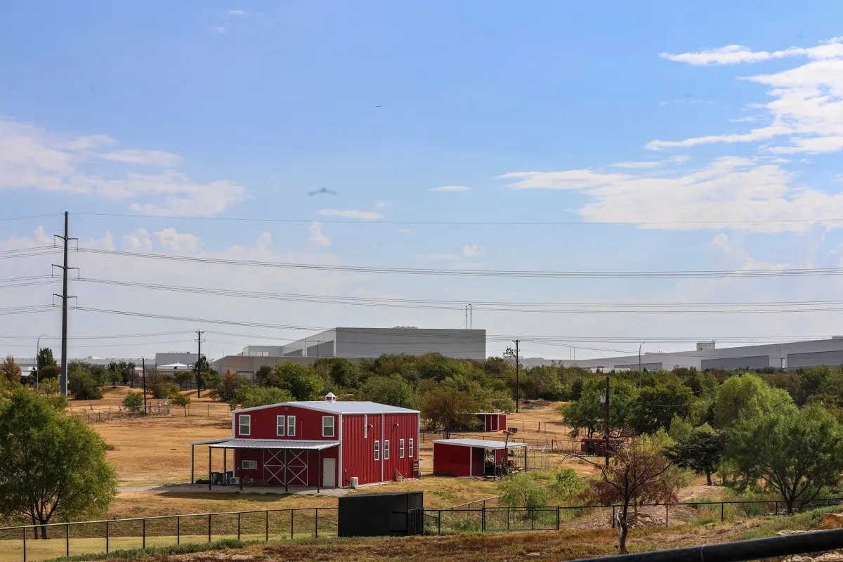 A house sits in front of a Meta data center in Roanoke, Texas on Sept. 11, 2026.